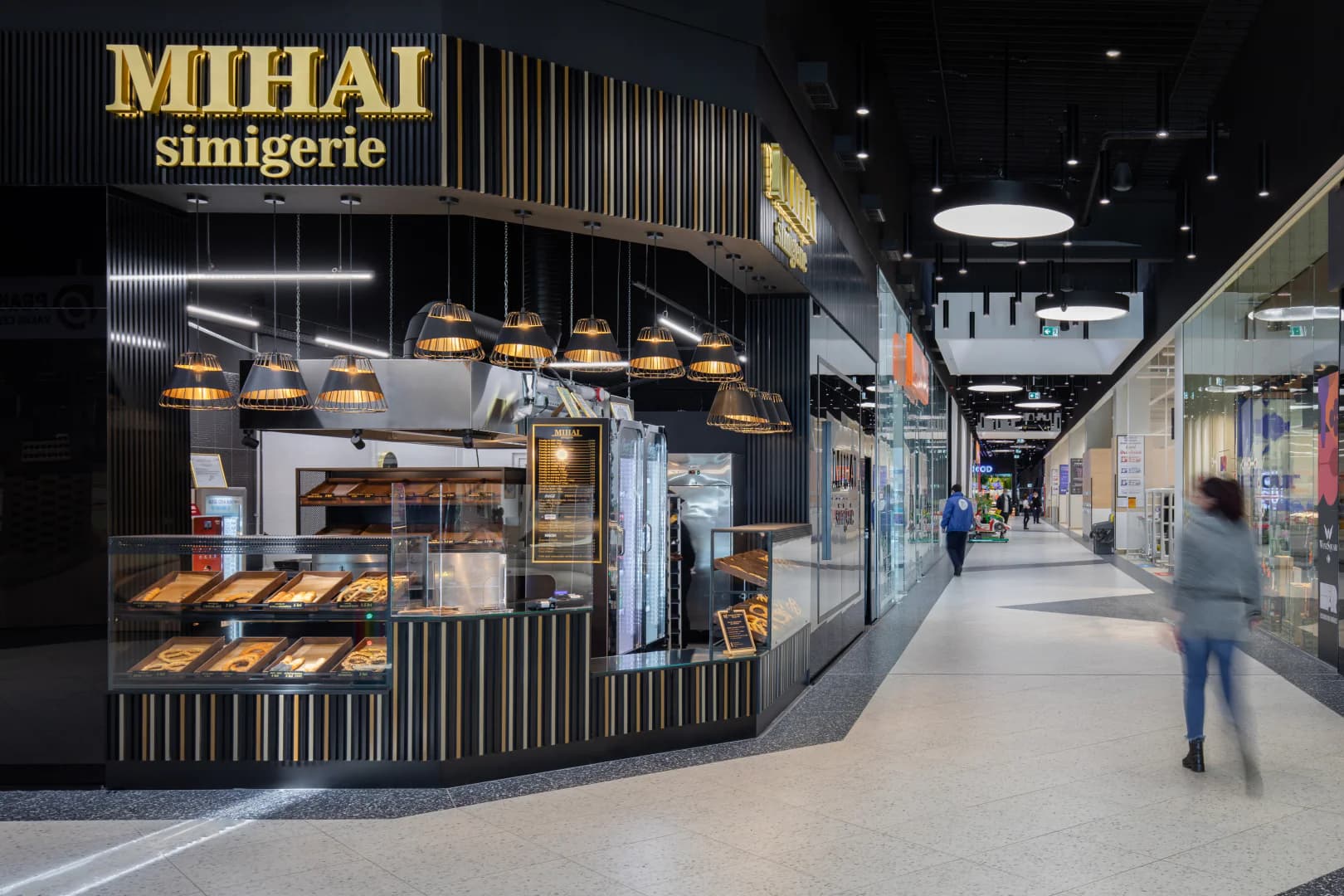 Mihai bakery in Value Center with black and gold design and pastry display cases